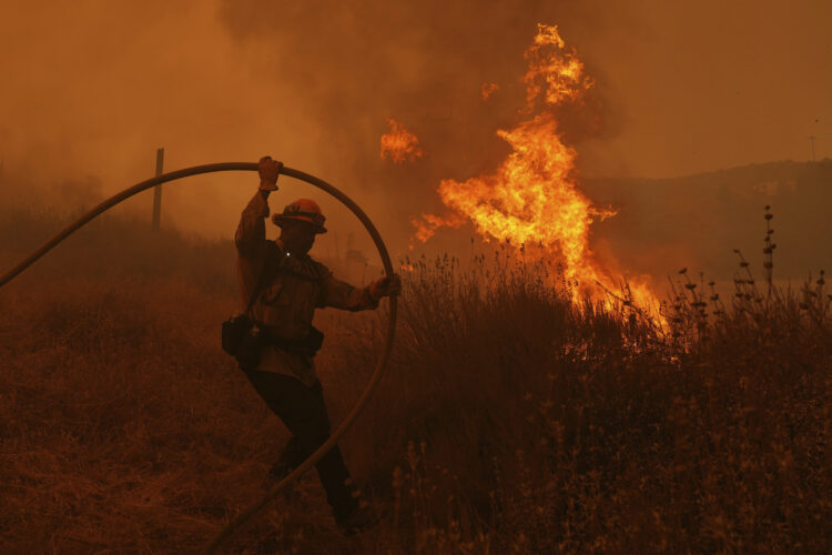 Firefighters make progress against blaze that forced thousands to